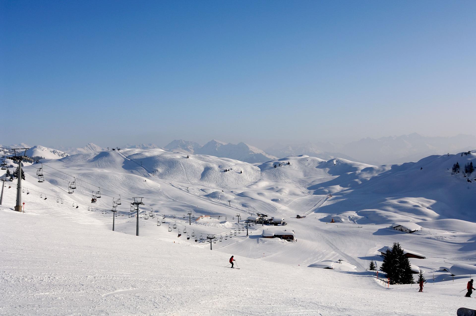 Skier skiing down wide open ski slope in Austria