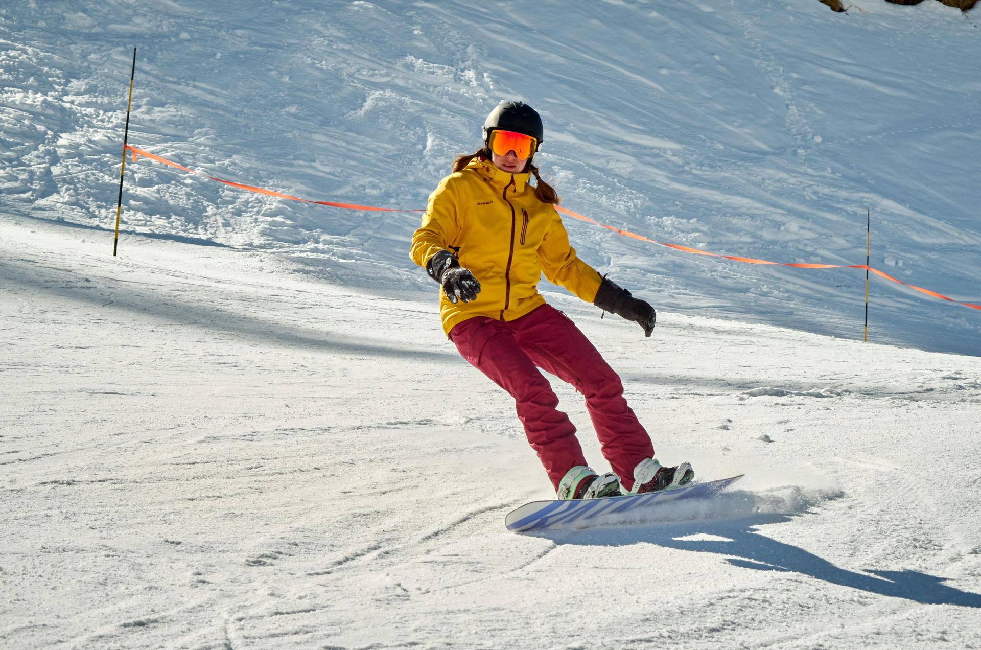 man-snowboarding-isola-2000-piste